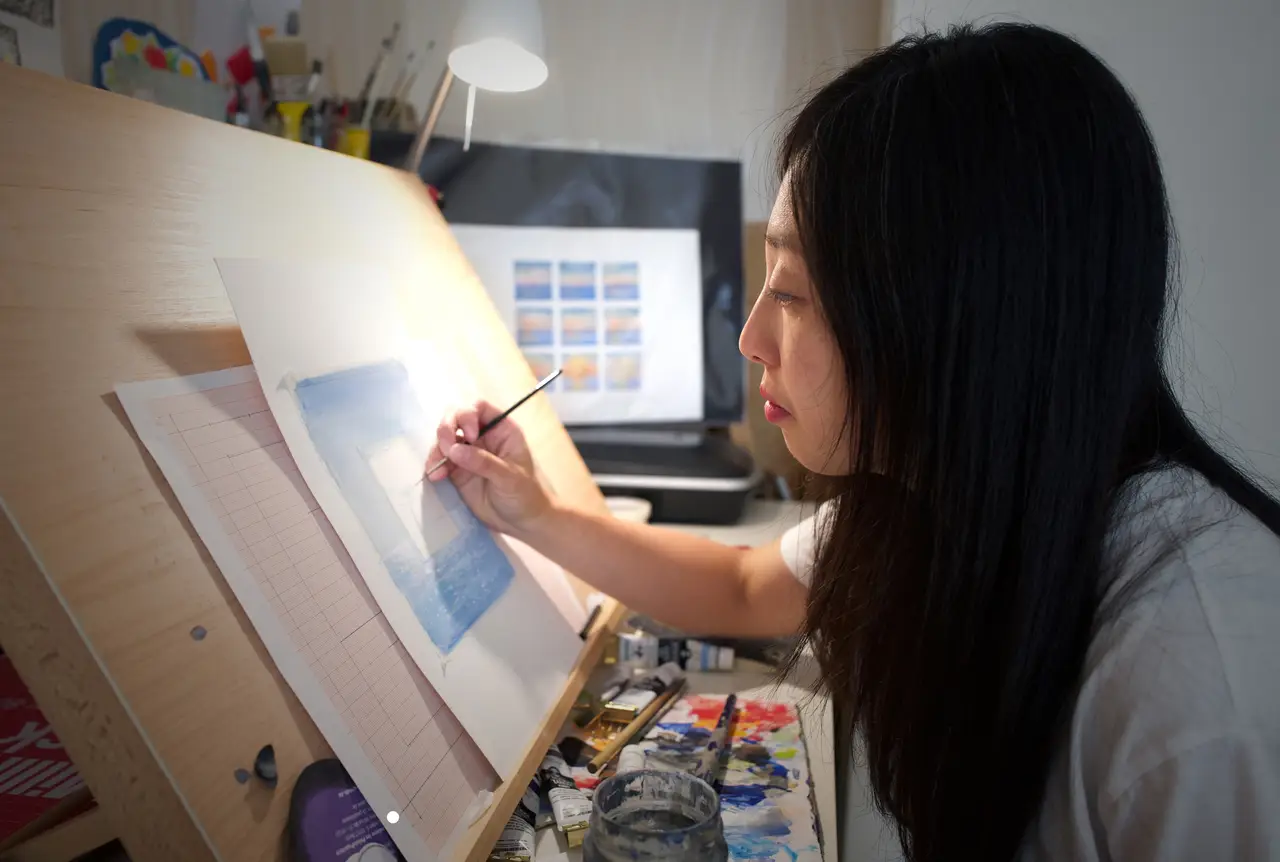 Risa Kusumoto working at her desk